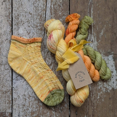 Flower Yarn Knitting Kits by Ainsworth & Prin with skeins and silk ribbon, showcasing Classic Sock yarn for creative projects.