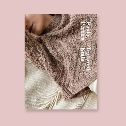 Book of Knitted shawl with textured pattern on a pink background