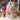 Soft and cuddly Inkari Stuffed Alpaca Animal on display, surrounded by colorful yarns and decor.