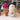 Inkari Stuffed Alpaca animal on display with colorful yarns and a small vase.
