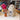 Stuffed Alpaca toy from Inkari displayed on a table with colorful yarn and a decorative vase, showcasing the Natural type.