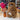 Stuffed Alpaca by Inkari in fluffy brown, standing on a table next to a decorative vase, perfect for cuddling and gifting.
