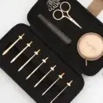 KnitPro Oasis Starter Interchangeable Crochet Hook Set with 7 hooks, scissors, tape, and markers in black case.