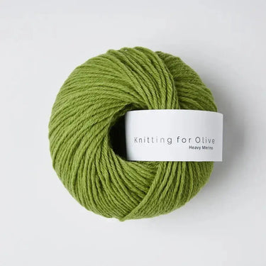 Green yarn ball of Knitting for Olive Heavy Merino wool, ideal for knitting warm, soft garments.