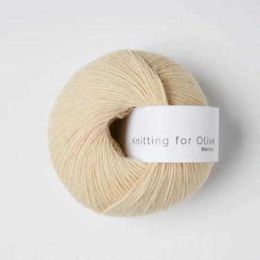 Knitting for Olive Heavy Merino yarn ball in natural color on a white background.