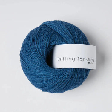 Knitting For Olive Merino yarn skein in blue, ideal for knitting projects with superb comfort and breathability.