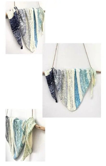 Hand-knitted swatches from Kokon Blue's "Knit Me An Ocean" Yarn Advent Calendar, showcasing blue and white mini skeins.