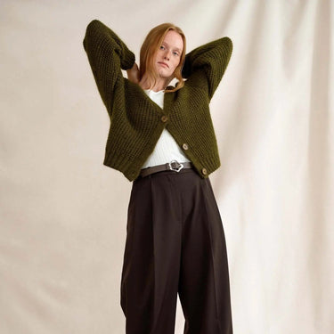 Model wearing a green knitted cardigan from Laine Magazine Issue 27 - Winter PRE-ORDER, featuring relaxed fit and modern design.