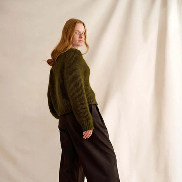 Model wearing a green knit sweater featured in Laine Magazine Issue 27 Winter PRE-ORDER.