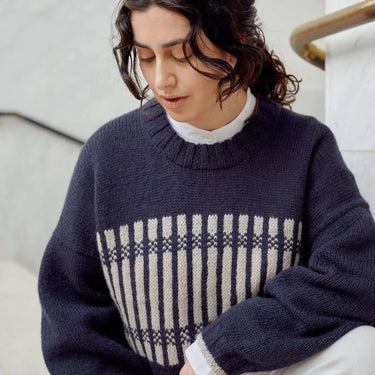 Model wearing a knit sweater featured in Laine Magazine Issue 27 - Winter PRE-ORDER, showcasing bold cables and innovative colorwork.