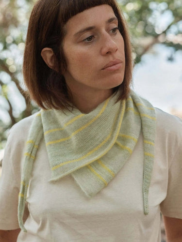 Woman wearing a knitted scarf, featured in Laine Magazine Spring 28 edition.
