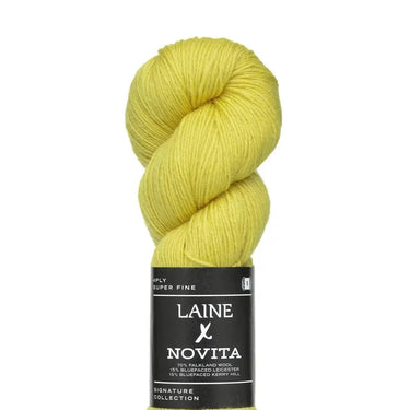 Yellow skein of yarn with Laine Novita label on a white background