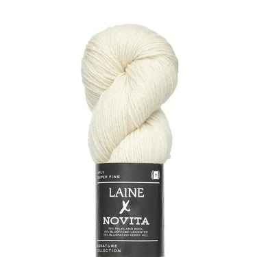 Ball of white yarn with Laine Novita label on a white background