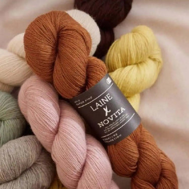 Colorful Laine x Novita yarn skeins at Jonna Helin event, November 7th, 4pm-7pm, showcasing creative designs in knitting.
