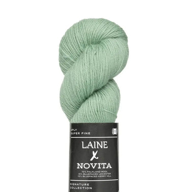 Green skein of yarn with a Laine Novita label on a white background