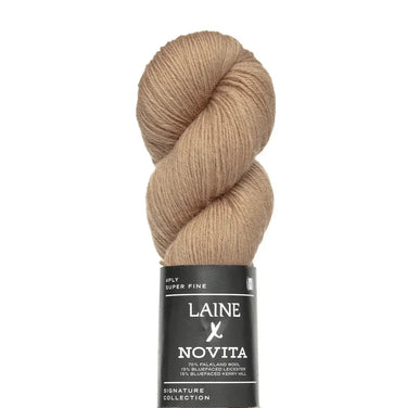 Beige skein of yarn with a Laine Novita label on a white background