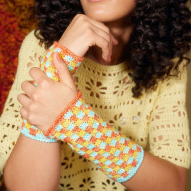 Colorful crochet wrist warmers featured in Let's Crochet Issue 2 magazine.