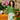 Model wearing green crochet sweater from Let's Crochet Issue 2 by Laine with vibrant decor and plants.