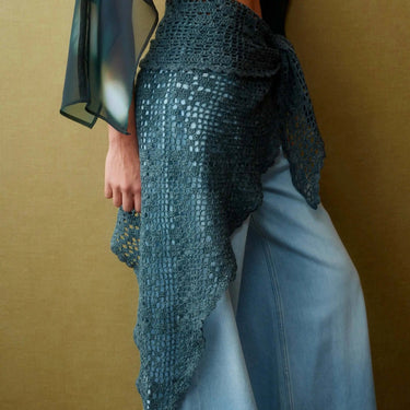 Model wearing a crochet wrap skirt featured in Let's Crochet Issue 2 by Laine, showcasing contemporary crochet design.