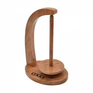 Lykke Pendel Yarn Holder in natural handcrafted wood for knitting and crocheting, featuring a magnetic rotating yarn spool.