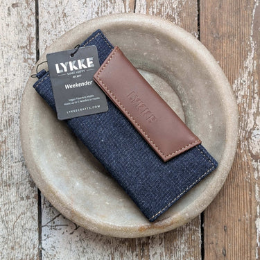 Lykke Weekender Knitting Needle Travel Case, denim and vegan leather, with magnetic closure, on wooden surface