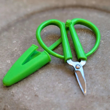 Bright green Mini Scissors with silicone cover guard for safety and travel convenience, great for on-the-go use.