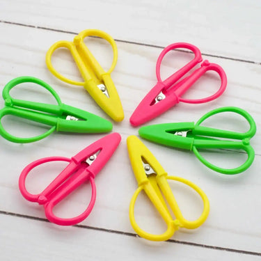 Colorful mini scissors with silicone guards, ideal for travel. Fox & Pine Mini Scissors measuring 2.5". Available in three colors.