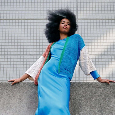 Model wearing vibrant crocheted clothing from Molla Mills Hooks Out collection