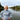 Woman wearing a knitted jumper by a river, promoting My First Knitted Jumper Workshop.