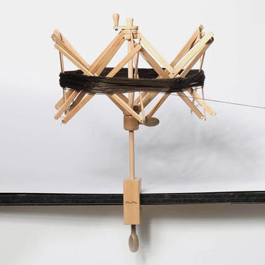 KnitPro Natural Wood Yarn Swift with a skein of yarn wound on, clamped to a table | Knit With Me