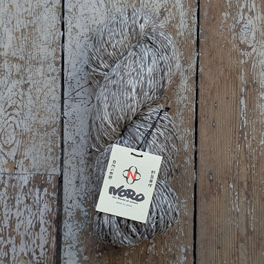 Skein of Noro Haunui Silk yarn on rustic wooden background