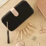 KnitPro Oasis Starter Interchangeable Crochet Hook Set with hooks, scissors, and markers displayed on beige surface