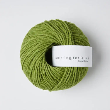 Green yarn ball of Knitting for Olive Heavy Merino wool, ideal for knitting warm, soft garments.
