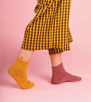 Stylish knitted socks from Ready Steady Sock Knitting Book by Pom Pom, showcasing sock designs for all knitters.