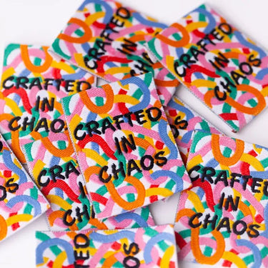 Colorful patches with 'Crafted in Chaos' text on a white background