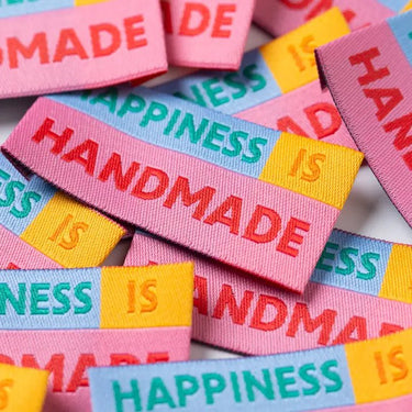 Colorful woven labels with text on a white background