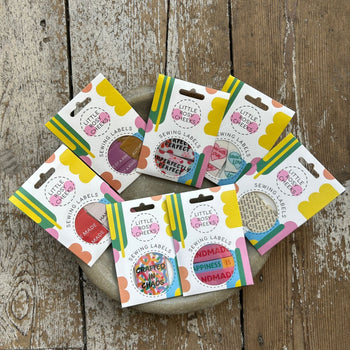 Group of labels for knitting projects in a bowl.