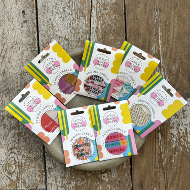 Group of labels for knitting projects in a bowl.