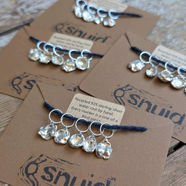 Handcrafted Silver Stitch Markers by Snuid displayed on cards