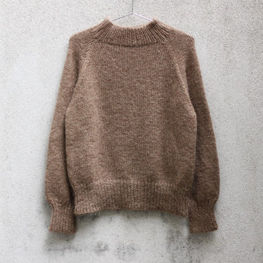Simple and Simple Sweater Kit knitted in KFO Merino and Soft Silk Mohair, hanging on a wall, at Knit With Me yarn shop