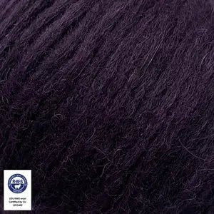 Close-up of Snefnug yarn in dark purple by CaMaRose, featuring a blend of baby alpaca, merino wool, and organic cotton.