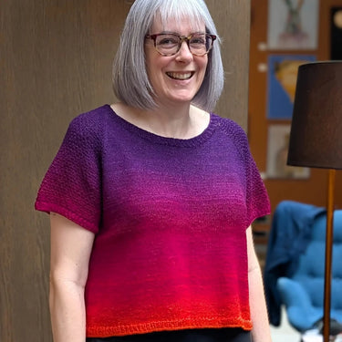 hand knitted Jumper knit in Bilium moving from red to purple.