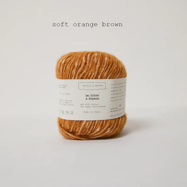 Le Coton & Alpaca soft orange brown yarn ball on white background
