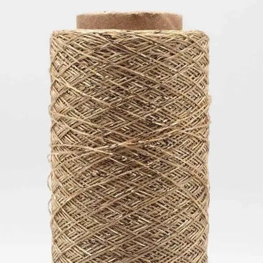 Spool of Kremke Soul Wool Stellaris yarn with a metallic shimmer, ideal for knitting and crochet projects adding glamor and elegance.