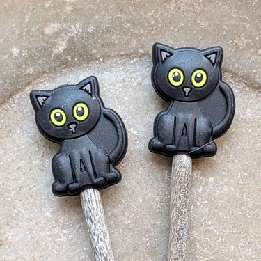 Stitch Stoppers cat design by Fox & Pine Stitches on knitting needles, preventing stitches from coming undone, essential knitting tool.