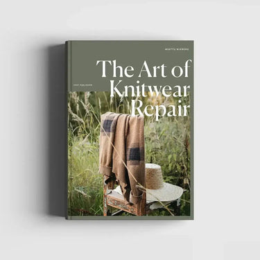 Book titled 'The Art of Knitwear Repair' with a plaid blanket and chair in a natural setting on the cover.