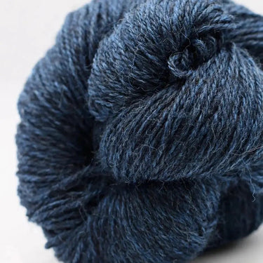Close-up of a skein of blue yarn on a light background