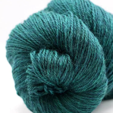 Teal skein of yarn on a white background