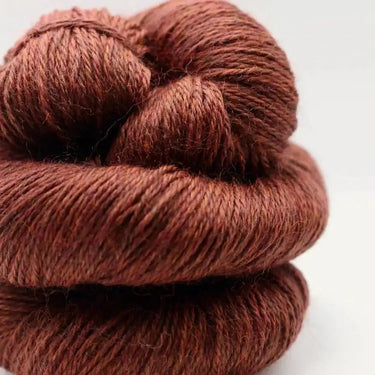 Yarnadelic Sport yarn made from 100% Falklands Corriedale in rich brown color, ideal for knitting and crochet projects.