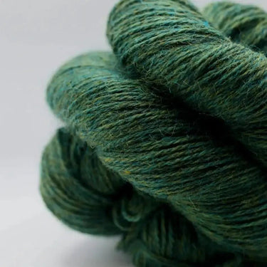 Close-up of green Yarnadelic Sport yarn made from 100% Falklands Corriedale wool, showcasing texture and quality.
